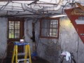 Start of job existing unfinished basement interior showing existing entrance door, windows and stairs at home on Wisconsin Ave. NW near Washington National Cathedral upper northwest Washington DC